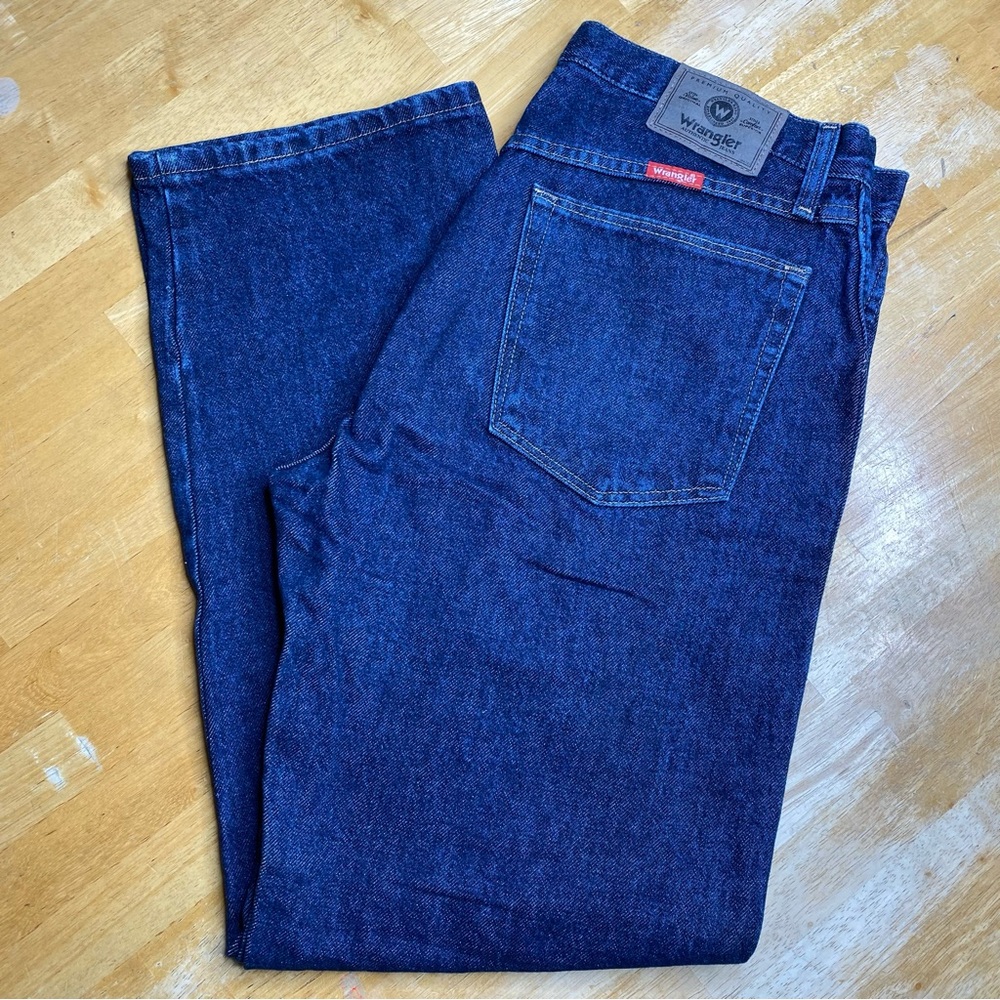 Vintage Wrangler Jeans with red tab label above pocket, dark wash